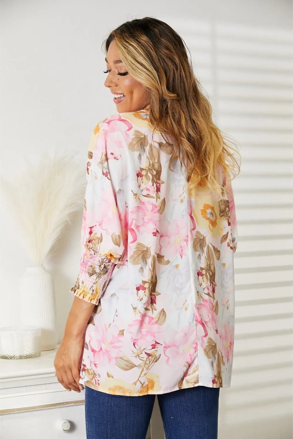 Blush pink floral round neck top with three-quarter sleeves from Trendsi, featuring a feminine and stylish design.