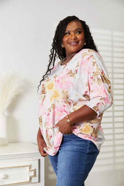 Blush pink floral round neck top with three-quarter sleeves from Trendsi, casual and stylish for spring or summer wear.