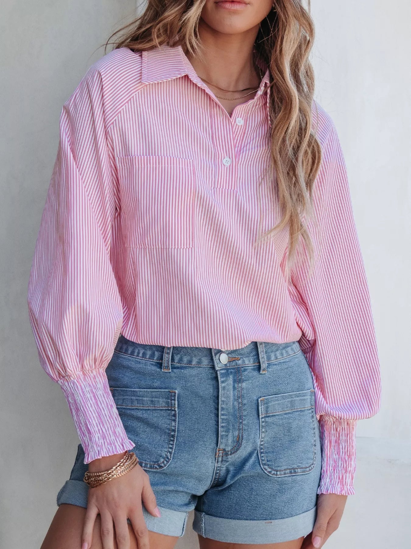 Blush pink pinstripe long sleeve button shirt with smocked cuffs and classic collar, trendy blouse by Trendsi.