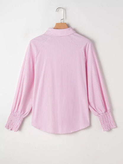 Blush pink pinstripe long sleeve blouse with smocked cuffs, button front, and shirt collar from Trendsi.