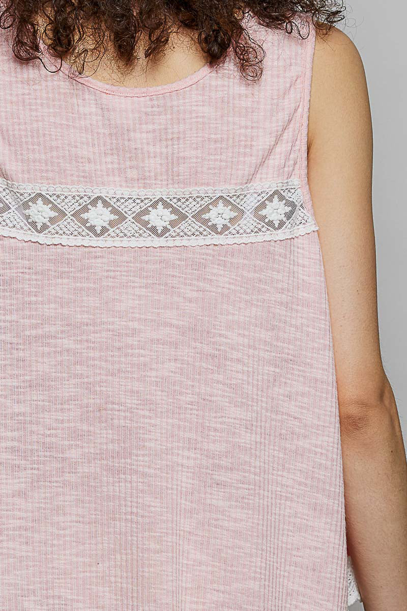 Blush pink sleeveless top with lace trim, ruffle hem, round neck, and button details from Trendsi.