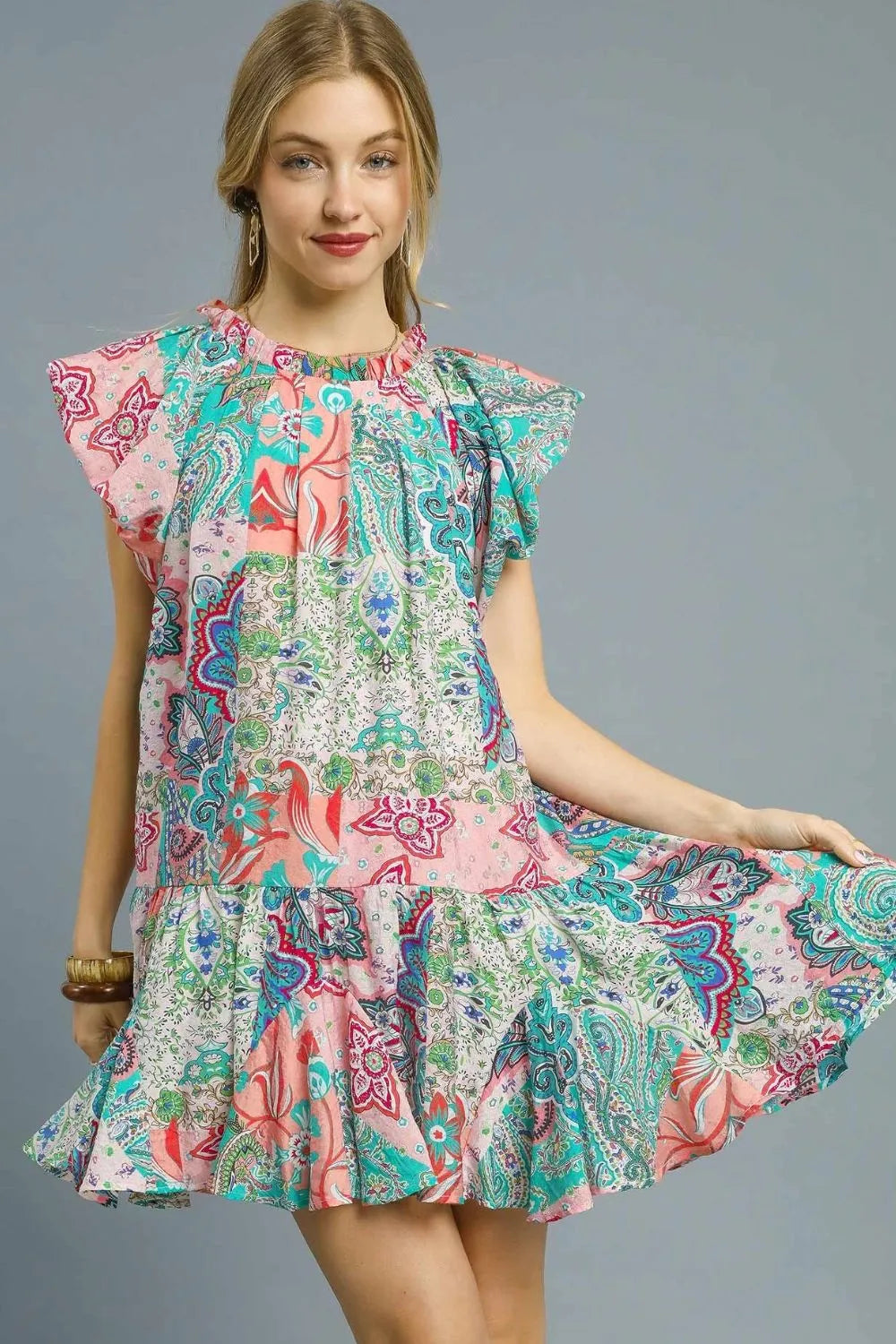 Blush pink Umgee printed ruffle cap sleeve mini dress with floral pattern and feminine design, perfect for casual or dressy occasions.