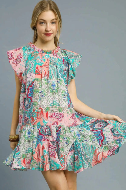 Blush pink Umgee printed ruffle cap sleeve mini dress with floral pattern and feminine design, perfect for casual or dressy occasions.