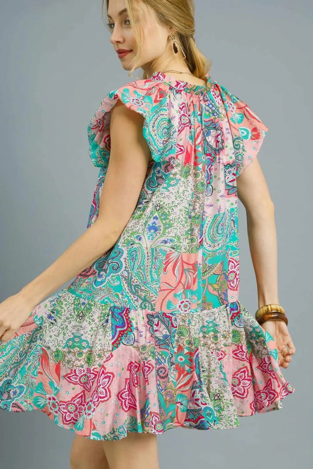 Blush pink Umgee printed ruffle cap sleeve mini dress, casual summer style with floral pattern and feminine ruffle details.