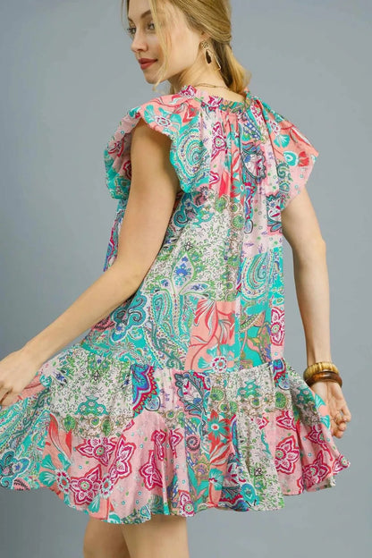 Blush pink Umgee printed ruffle cap sleeve mini dress, casual summer style with floral pattern and feminine ruffle details.