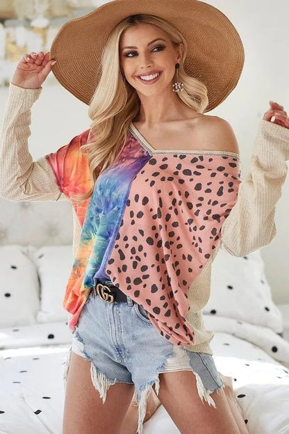 Blush BiBi print block V-neck top with contrast stitching from Trendsi, featuring a relaxed fit and stylish design.