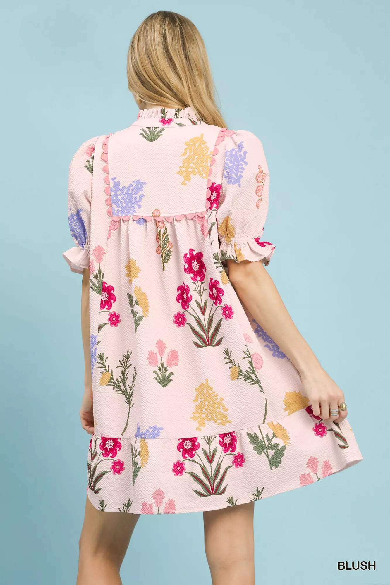 Blush Umgee multi-flower print V-neck dress from Trendsi, featuring a flowy fabric and vibrant floral pattern.