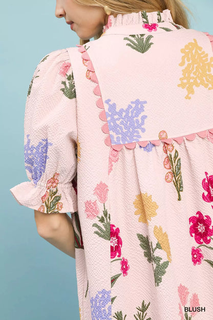 Umgee multi-flower print V-neck dress in soft blush fabric, featuring a stylish and feminine design.