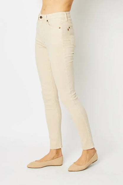 Full body view of Judy Blue full-size garment dyed tummy control skinny jeans on a model, showing their fit and color.