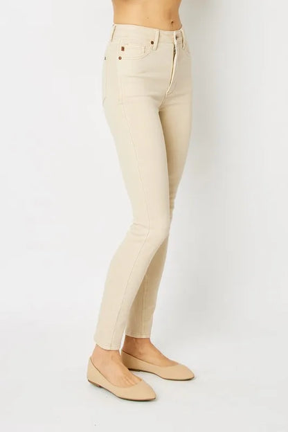 Full-length Judy Blue skinny jeans with garment dye and tummy control, shown in a size 0 fit on a model.