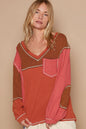 Brick-colored POL V-neck knit top with panel design and exposed seams by Trendsi, shown on a model.