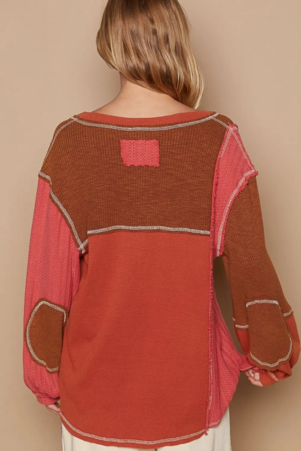 Brick-colored Trendsi POL V-neck knit panel top with exposed seams, featuring a relaxed fit and soft knit fabric.
