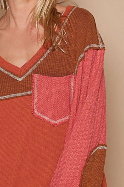 Brick-colored Trendsi POL V-neck knit top with panel design and exposed seams, featuring a relaxed fit and casual style.