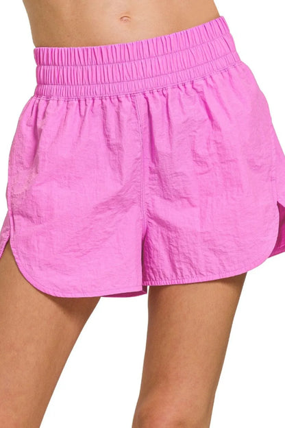 Bright mauve Zenana windbreaker running shorts with smocked waistband, designed for active wear and comfortable movement.
