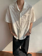 Men's plus size textured knit short-sleeve shirt in brown from Trendsi, featuring a casual, comfortable fit and detailed knit fabric.