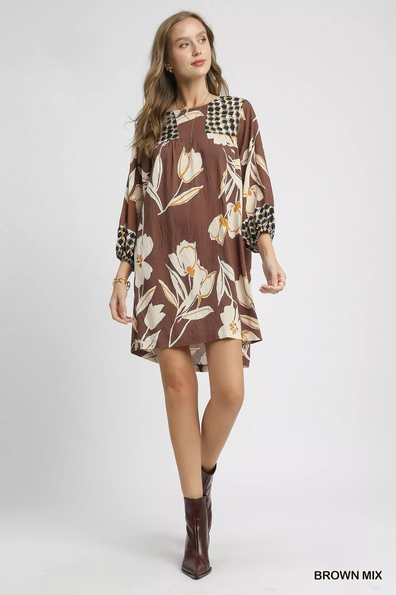 Brown floral high-low babydoll dress by Umgee featuring a flowy silhouette and feminine design, perfect for casual or dressy occasions.