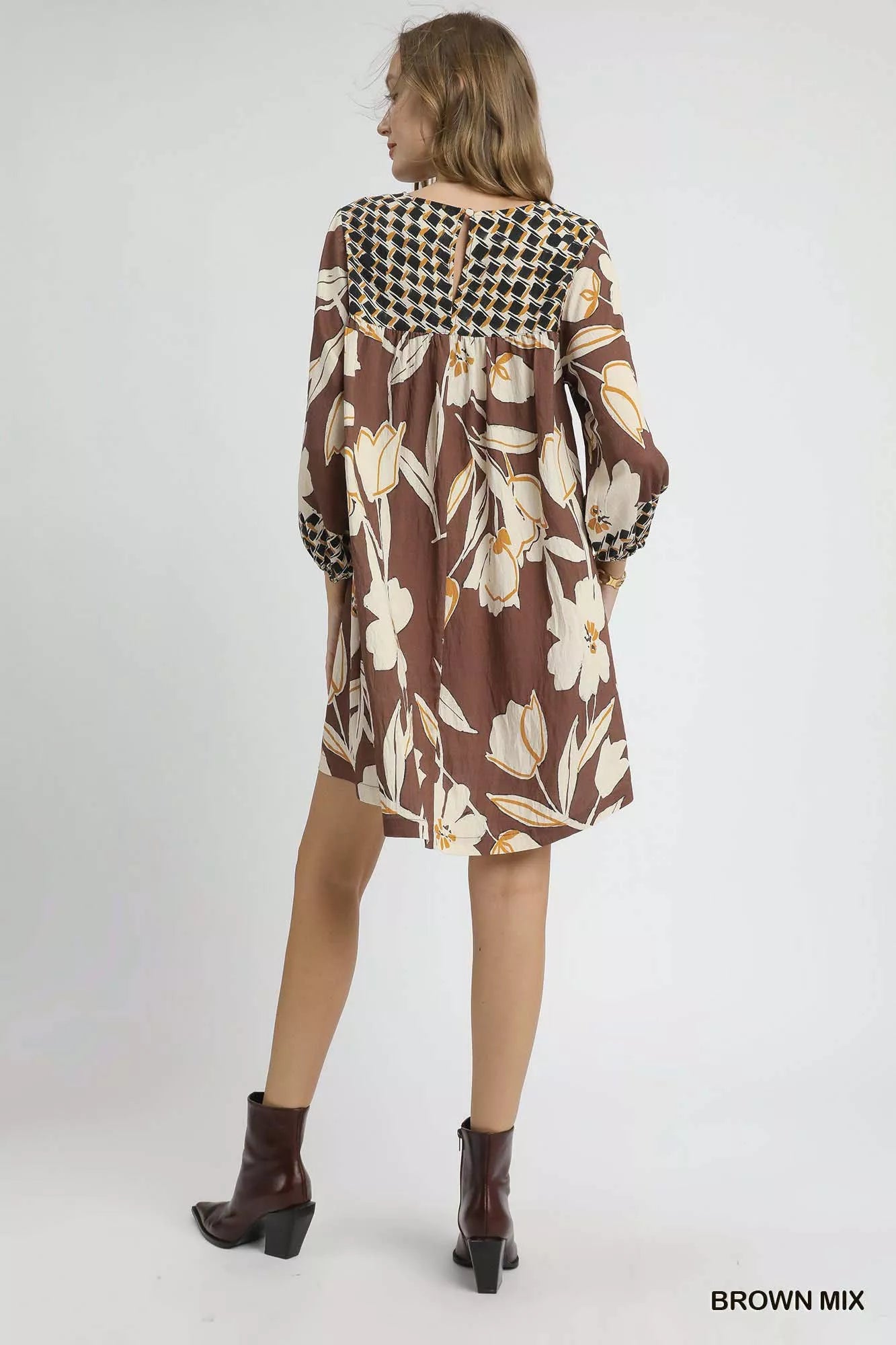 Brown floral high-low babydoll dress by Umgee featuring a flowy silhouette and ruffled hem, perfect for casual or dressy occasions.
