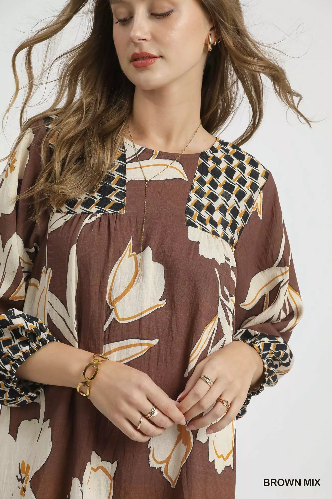 Brown floral high-low babydoll dress by Umgee featuring a relaxed fit and feminine design, perfect for casual and summer wear.