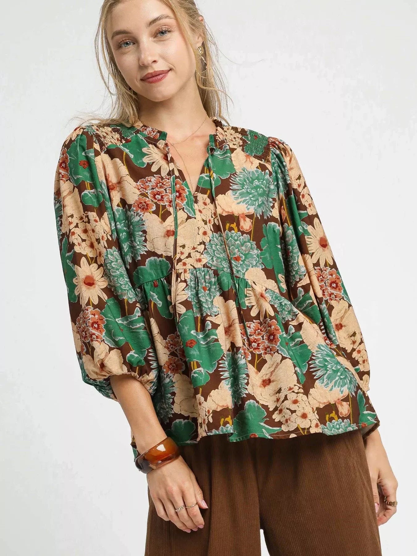 Brown Umgee floral peplum blouse with tie neck and long sleeves, stylish women's top with a mixed floral pattern.
