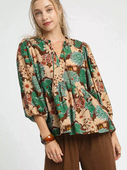 Brown Umgee floral peplum blouse with tie neck and long sleeves, stylish women's top with a mixed floral pattern.