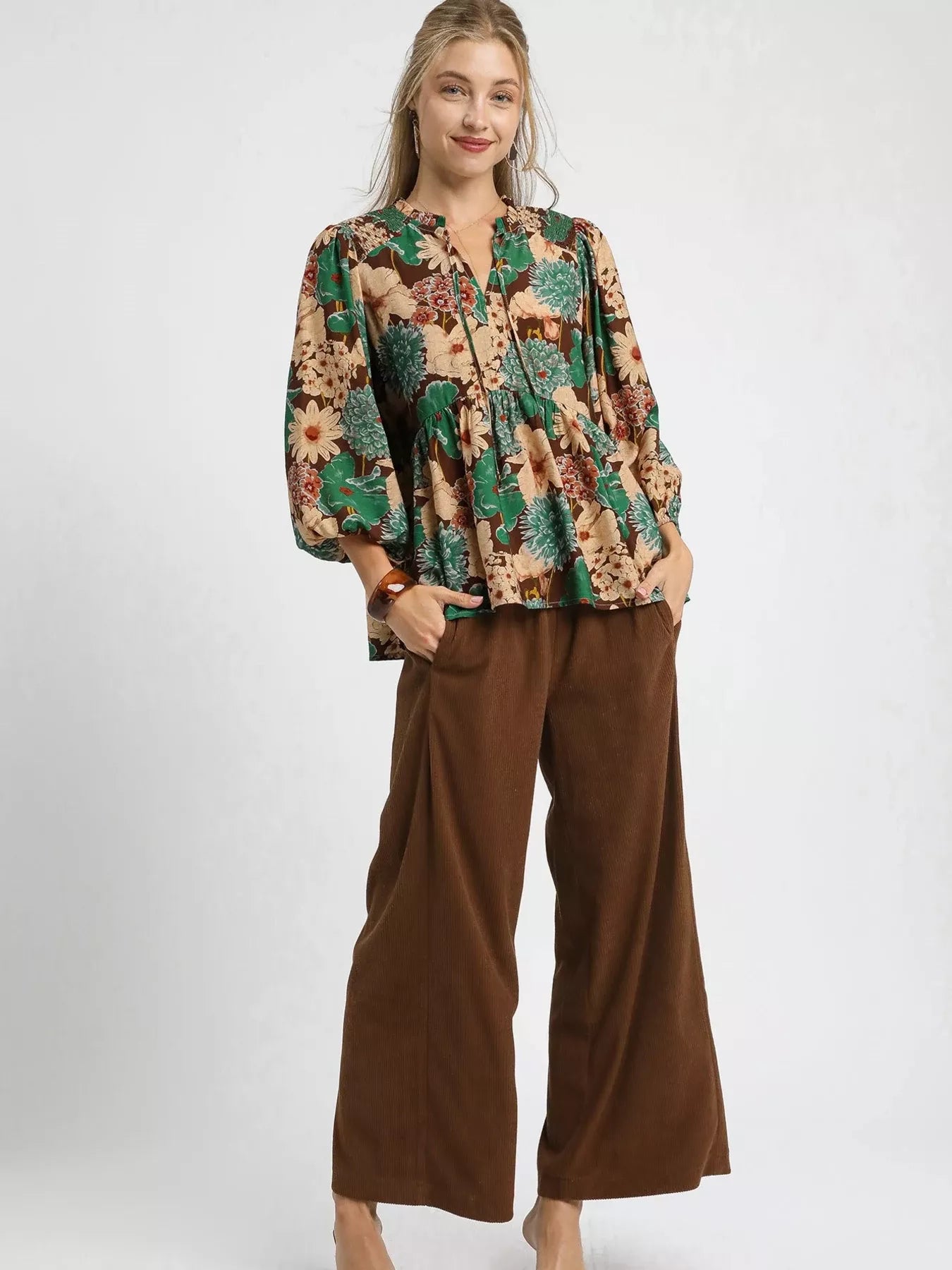 Brown floral peplum blouse with tie neck by Umgee, featuring mixed floral pattern and stylish design.