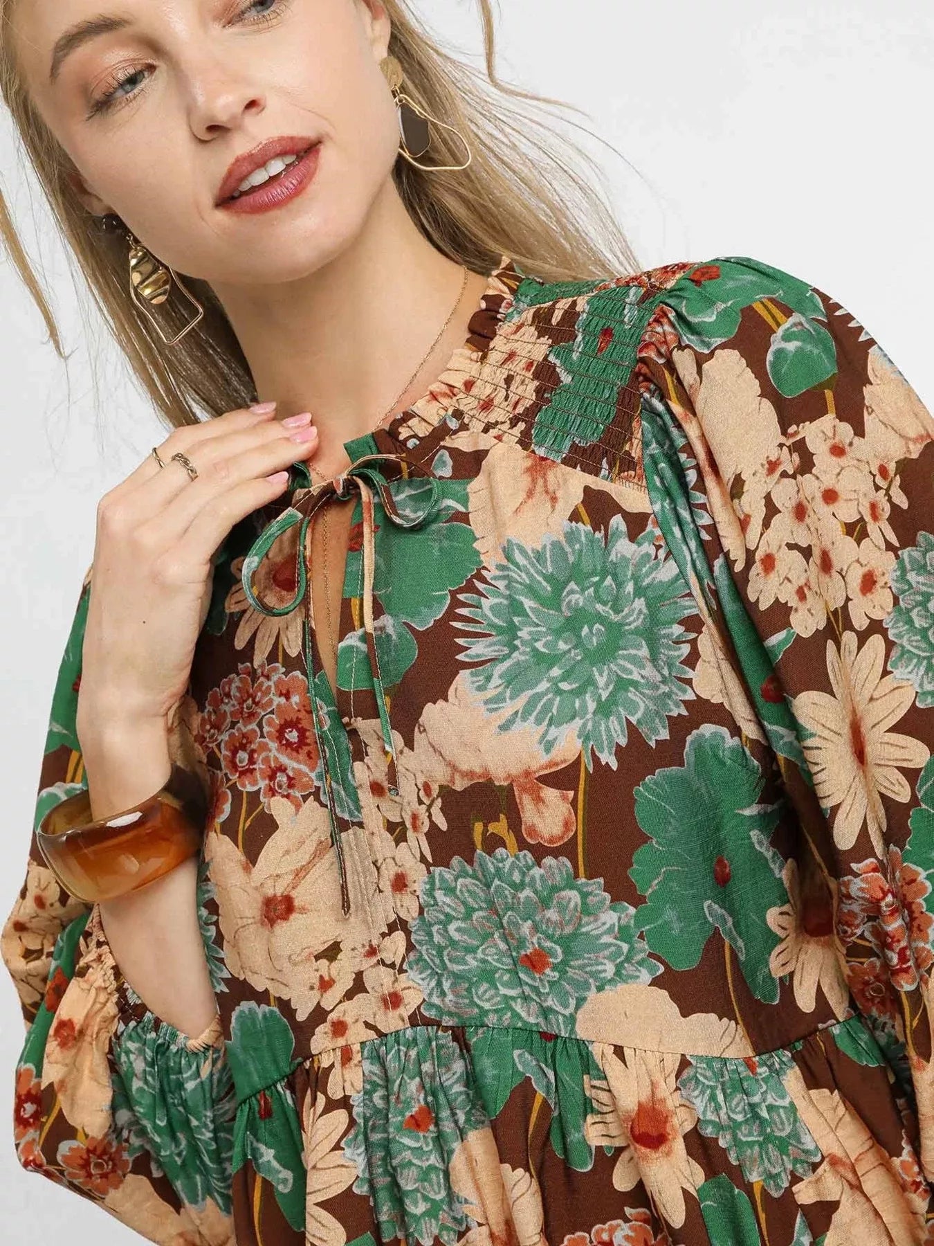 Brown floral peplum blouse with tie neck from Umgee, featuring a trendy mixed floral print and feminine design.