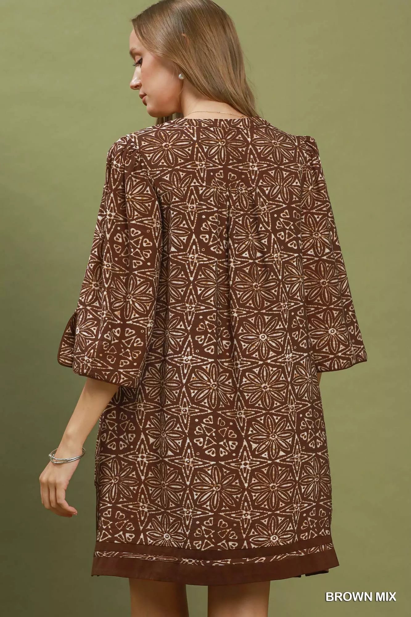 Brown Umgee geometric print tunic dress with V-neck and tassel detail, casual and stylish for everyday wear.
