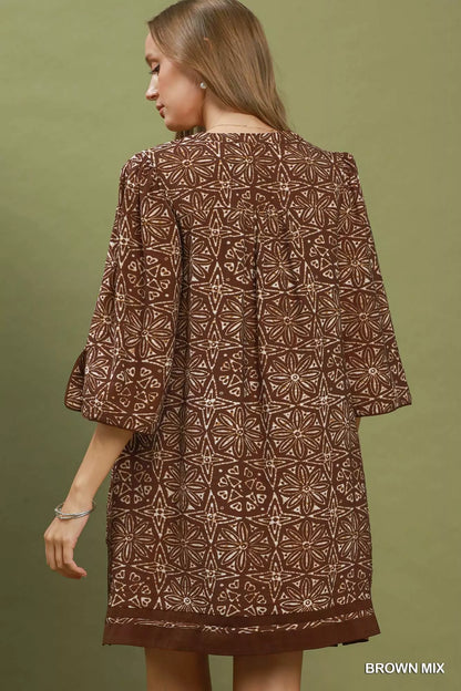 Brown Umgee geometric print tunic dress with V-neck and tassel detail, casual and stylish for everyday wear.