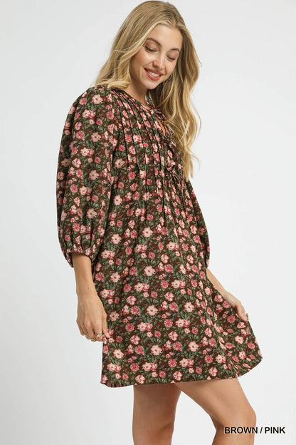 Brown and pink floral Umgee tie-neck babydoll dress with long sleeves and a relaxed fit, perfect for casual or spring wear.