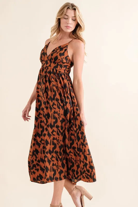 Leopard print plunge maxi dress from Trendsi featuring a fitted bodice and flowing skirt, perfect for stylish evening wear.
