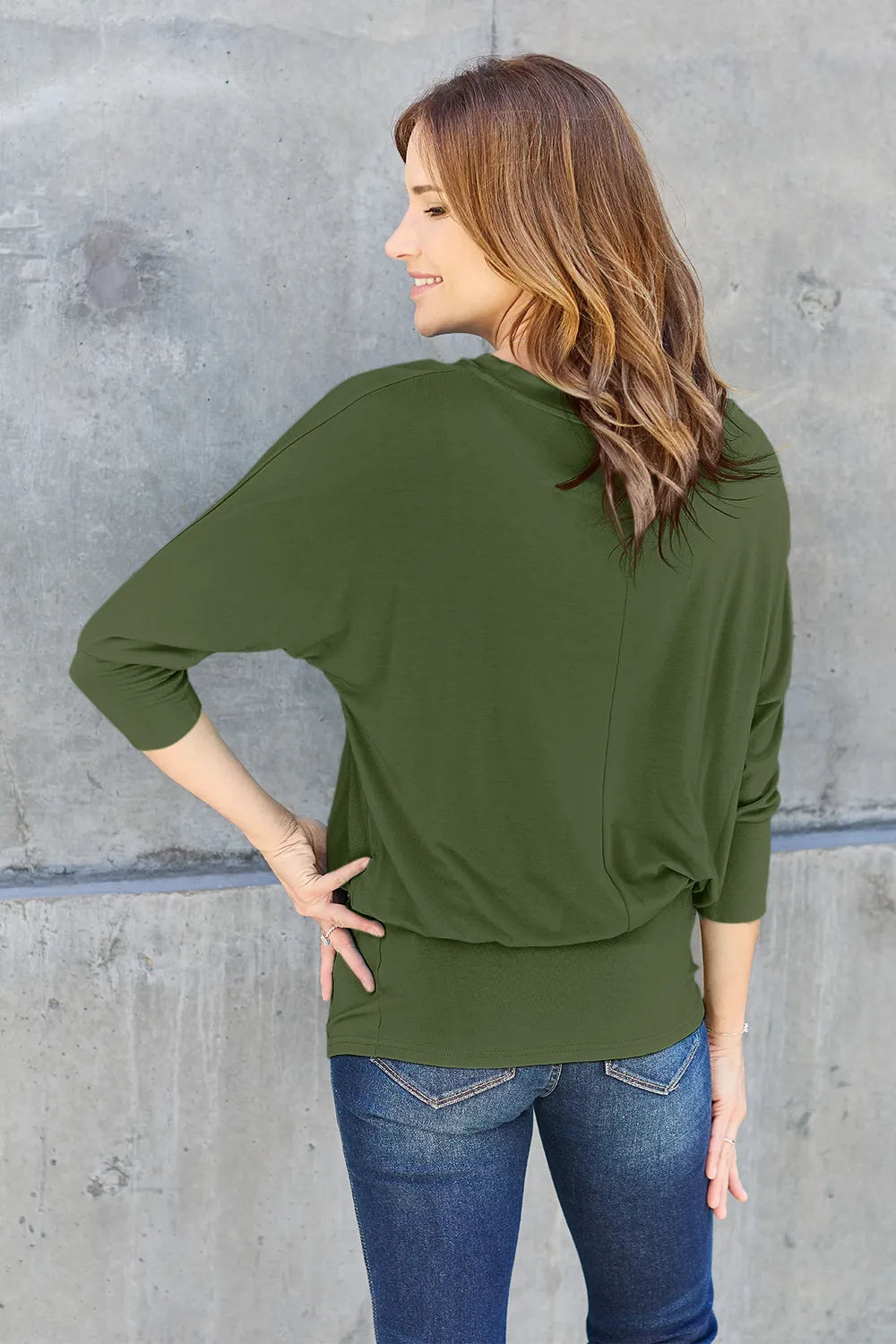 Brown Basic Bae full-size round neck batwing sleeve top by Trendsi, shown on a model, highlighting the relaxed fit and stylish design.