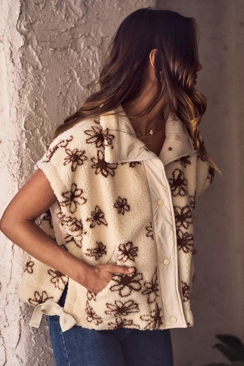 Brown SO ME Flower Sherpa Fur oversized sleeveless vest jacket with plush Sherpa lining and floral pattern detail.
