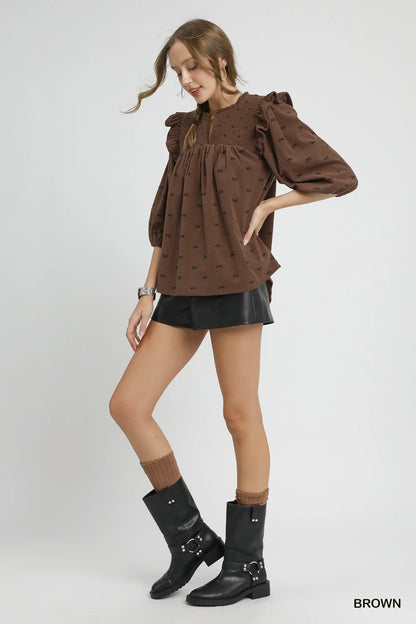 Brown Umgee bow print corduroy puff sleeve blouse with ruffled details, featuring a stylish vintage-inspired design.
