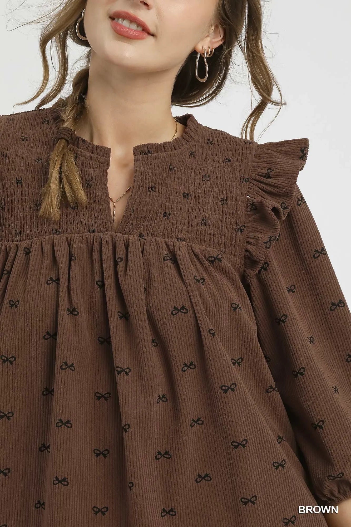 Brown Umgee bow print corduroy puff sleeve blouse with ruffled details, featuring a stylish and feminine design.