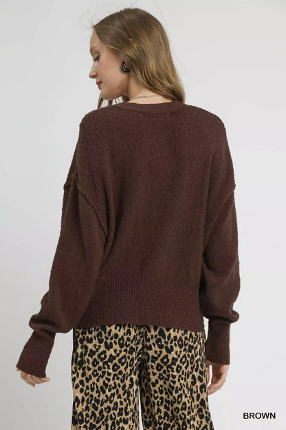 Brown Umgee button-front V-neck knit cardigan with long sleeves and ribbed cuffs, displayed on a hanger against a neutral background.