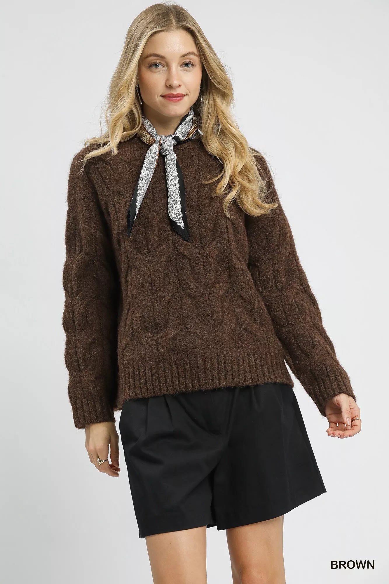 Brown Umgee Cable Knit Cozy Sweater from Trendsi, featuring a classic knit pattern and relaxed fit, perfect for cold weather.