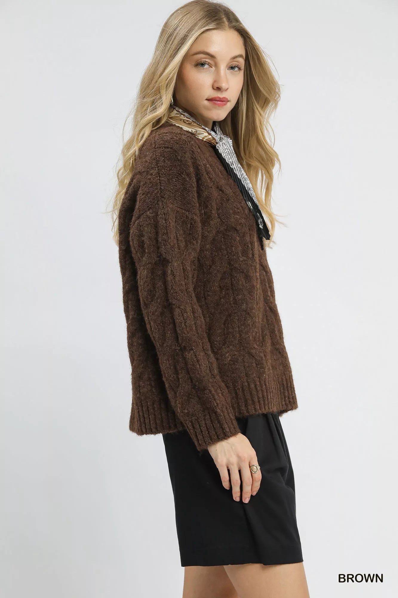 Brown Umgee cable knit cozy sweater with a textured knit pattern, long sleeves, and a relaxed fit.
