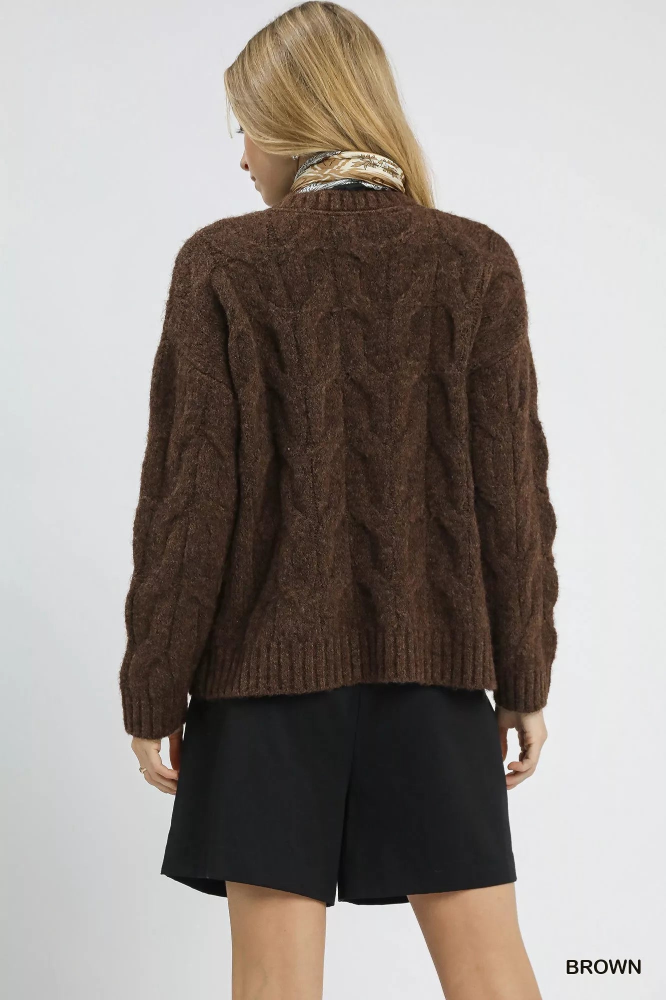 Brown Umgee cable knit cozy sweater from Trendsi, featuring a classic knit pattern and a comfortable, relaxed fit.