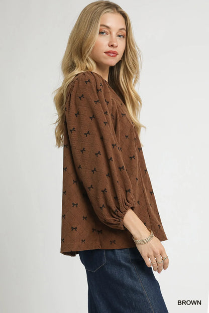 Brown Umgee corduroy balloon sleeve blouse with bow print and stylish details, perfect for casual or chic outfits.