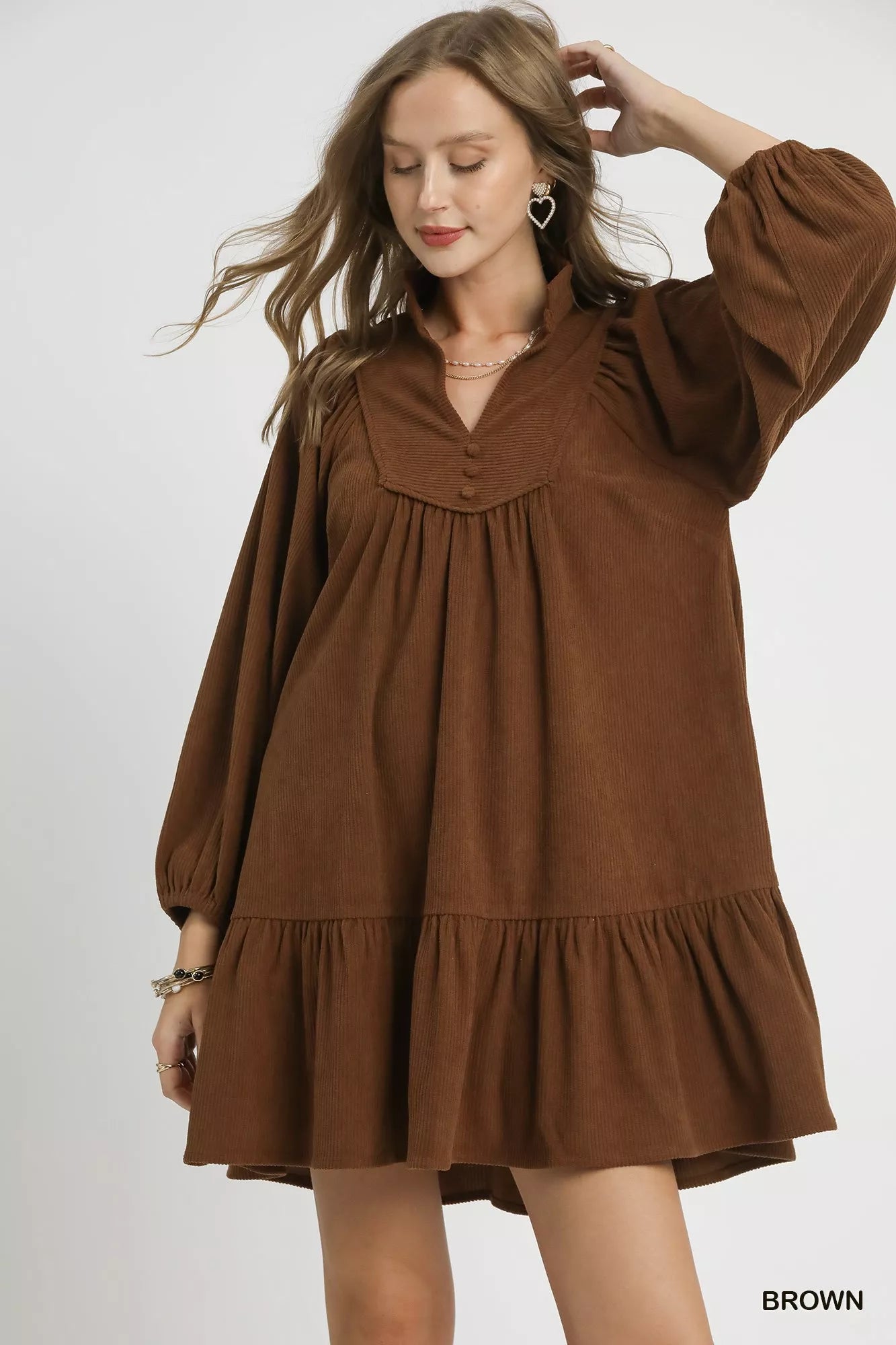 Brown Umgee corduroy tiered babydoll dress with long sleeves and a relaxed fit, styled for casual wear.