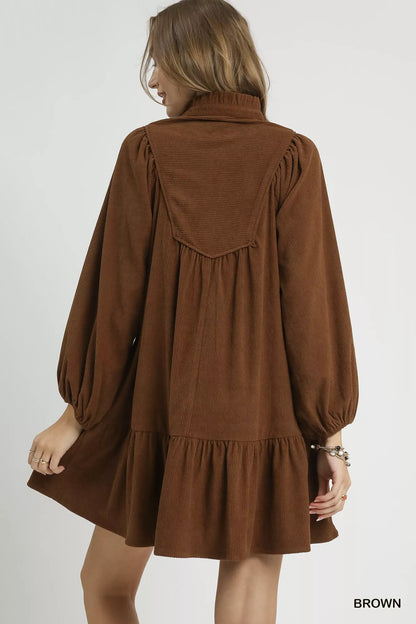 Brown Umgee corduroy tiered babydoll dress with long sleeves and a relaxed fit, styled for casual wear.