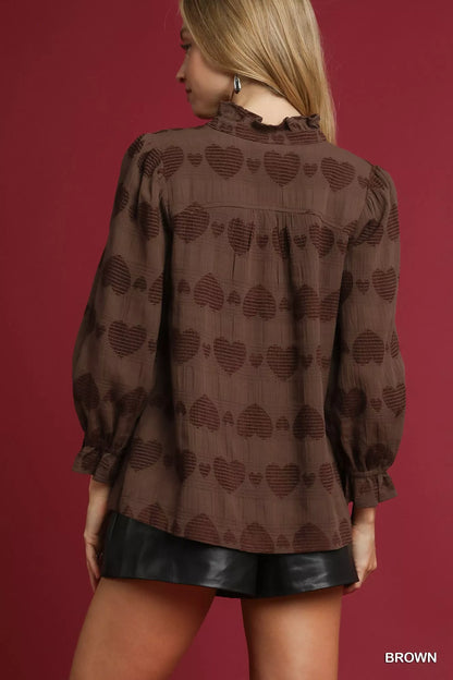 Brown Umgee Heart Jacquard Ruffle Trim Shirt with feminine ruffle details and intricate heart pattern, styled for casual wear.