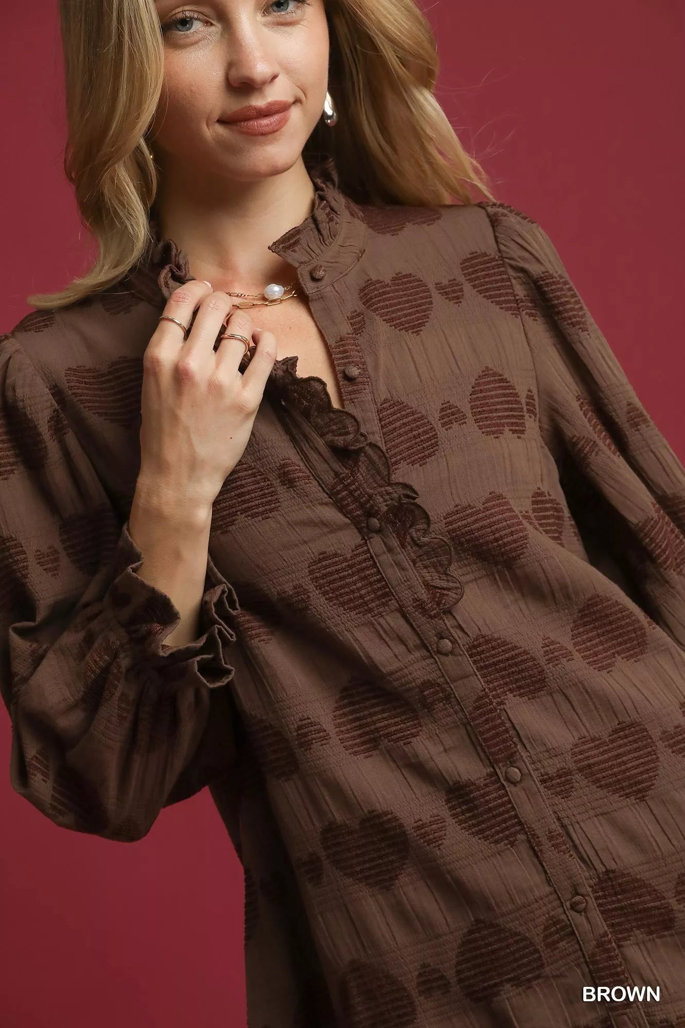 Brown Umgee Heart Jacquard Ruffle Trim Shirt with feminine ruffle details and intricate heart pattern, casual chic style.