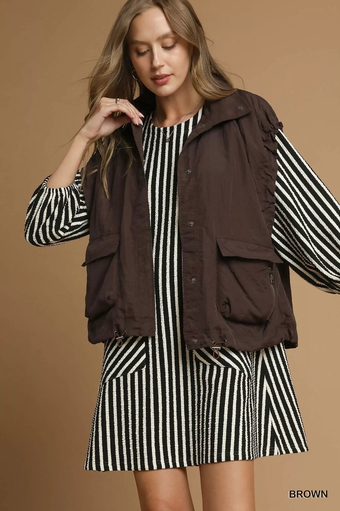 Brown Umgee nylon vest with pockets, featuring a lightweight design and casual style, perfect for layered outfits.