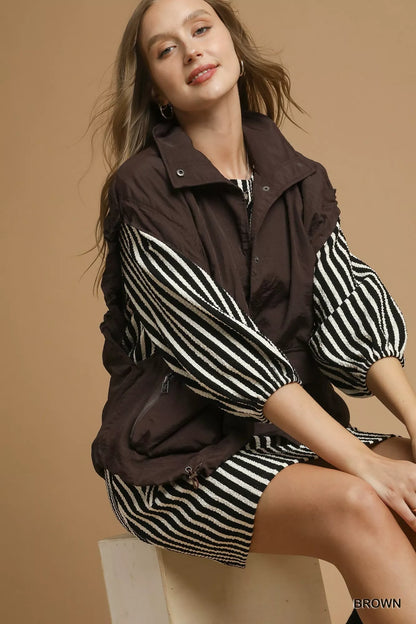 Brown Umgee nylon vest with front pockets, lightweight and casual, styled for trendy outdoor or everyday wear.