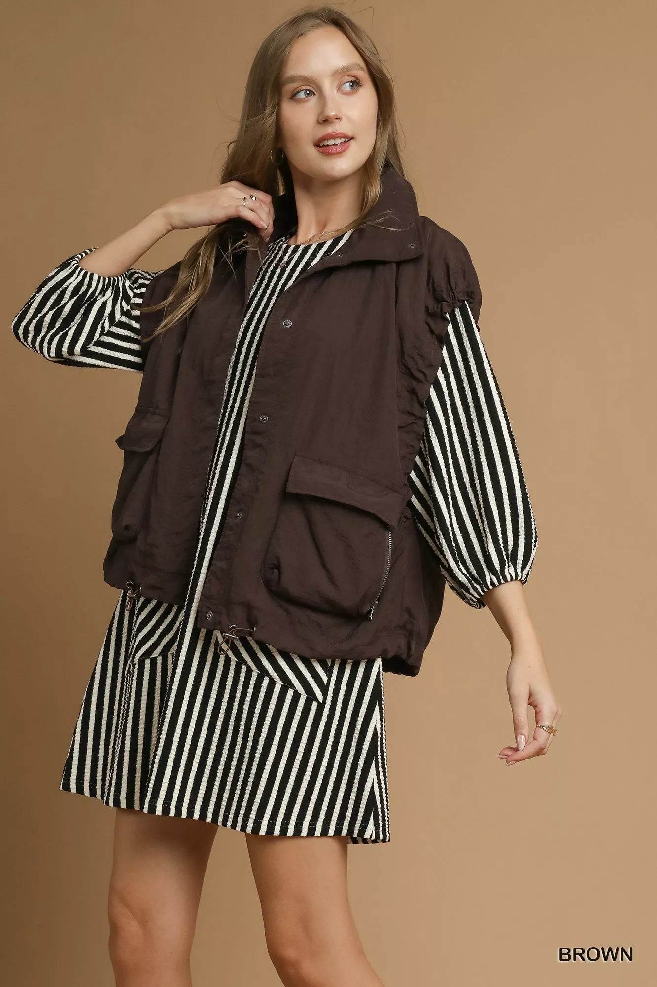 Brown Umgee nylon vest with front pockets, featuring a stylish and casual design, perfect for layering in trendy outfits.