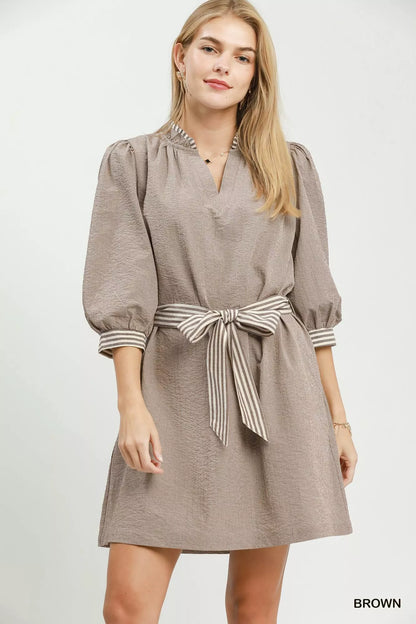 Brown Umgee textured mini dress with contrast trim, tie waist, perfect for casual or semi-formal wear.