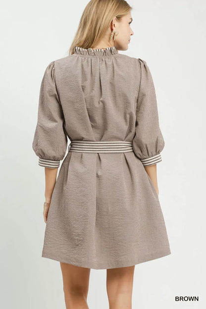Brown Umgee textured mini dress with contrast trim, tie waist, perfect for casual or stylish summer looks.