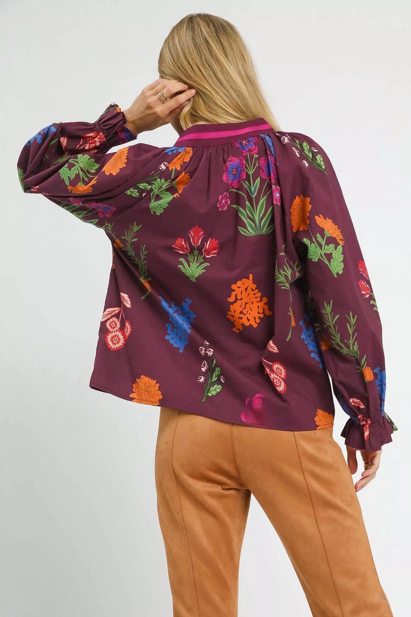 Floral print burgundy Umgee blouse with flounce sleeves, stylish women's top by Trendsi, displayed on a model.