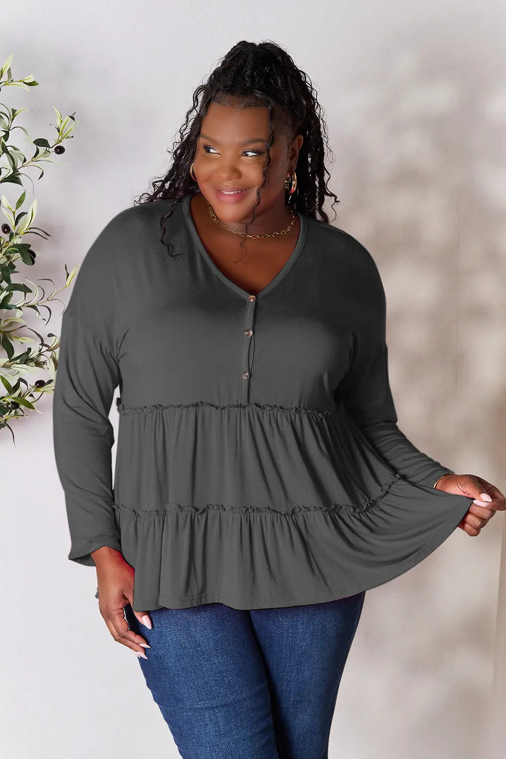 Burgundy Trendsi Double Take half-button long sleeve blouse with ruffle hem and casual fit, shown on a white background.